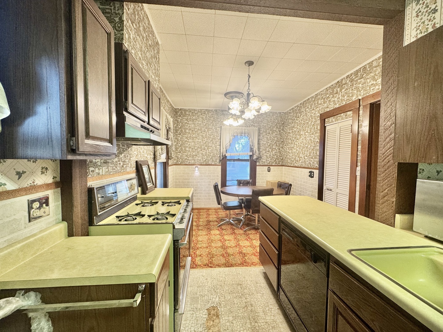 303 South Elm Street Clinton, IL 61727 - Photo 6 of 17 a large kitchen with a table chairs and refrigerator