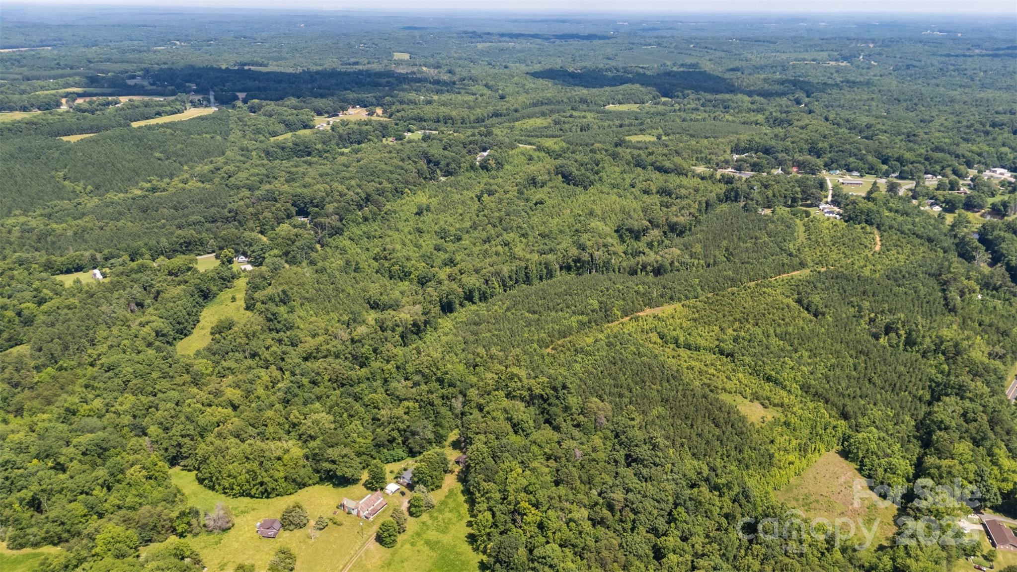 5600 Walters Mill Road Providence, NC 27315 - Photo 7 of 12 an aerial view of residential houses with outdoor space and trees
