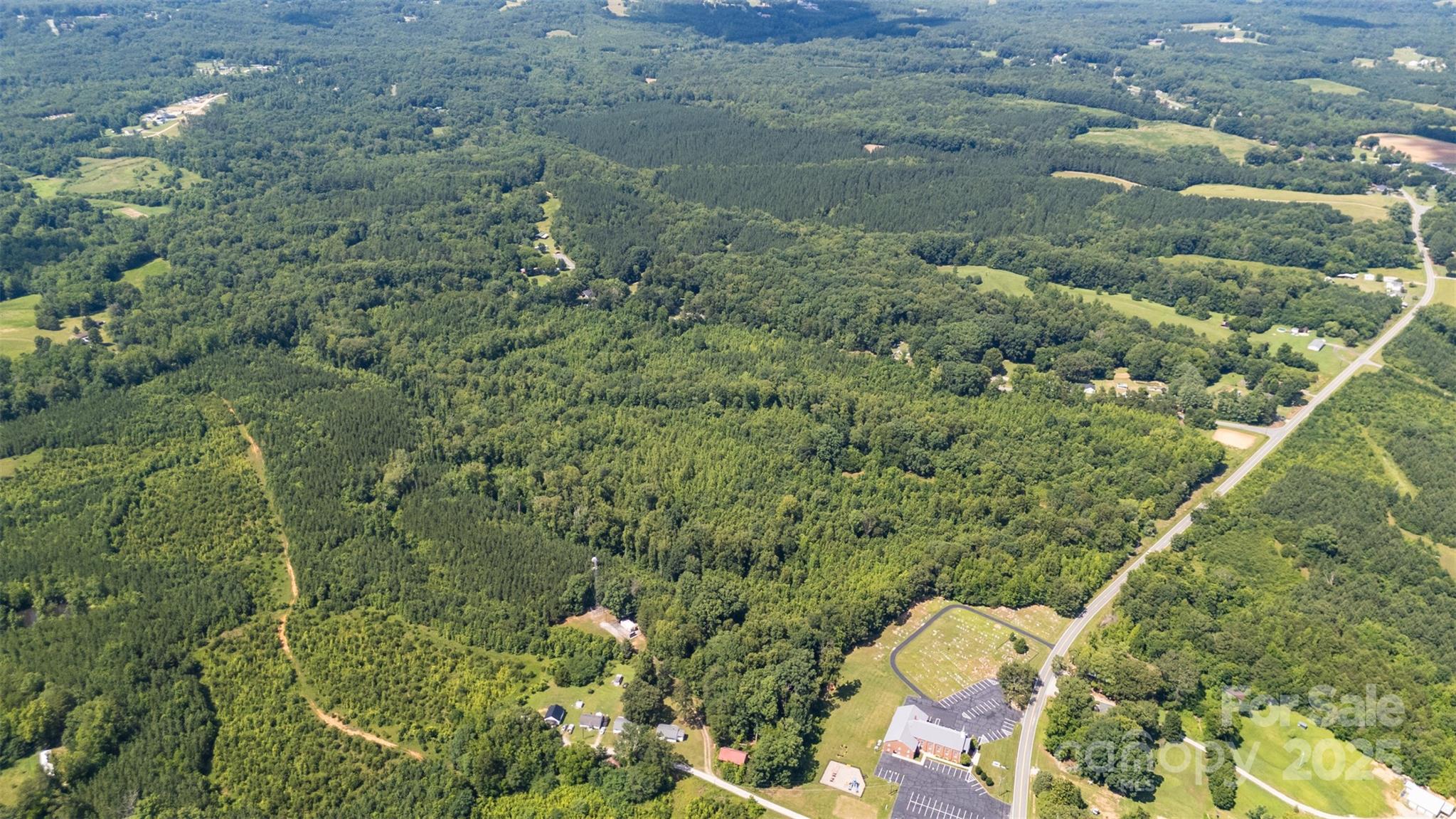 5600 Walters Mill Road Providence, NC 27315 - Photo 10 of 12 a aerial view of a house with a yard and large trees