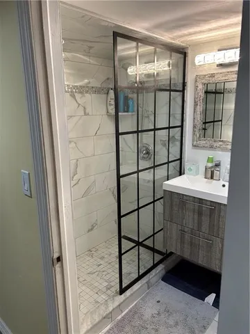 a bathroom with a shower and mirror
