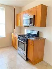 a kitchen with stainless steel appliances granite countertop a stove and a microwave