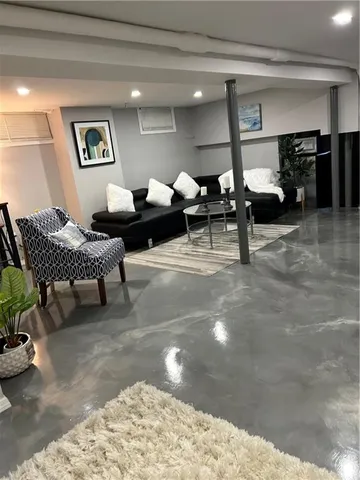 a living room with furniture and view of kitchen