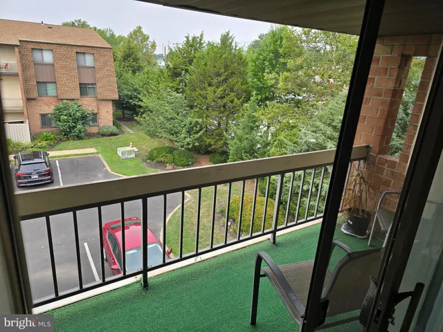 a view of a balcony with yard