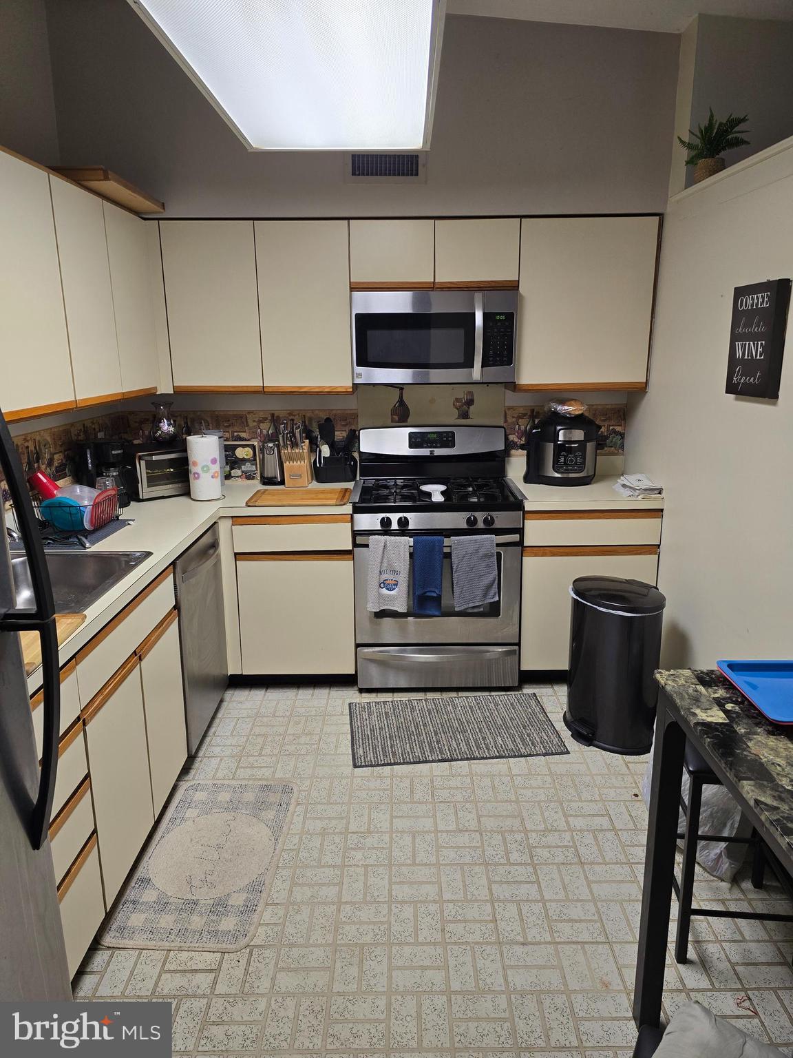 58201 Delaire Landing Road, Unit 201 Philadelphia, PA 19114 - Photo 4 of 11 a kitchen with a stove sink and cabinets