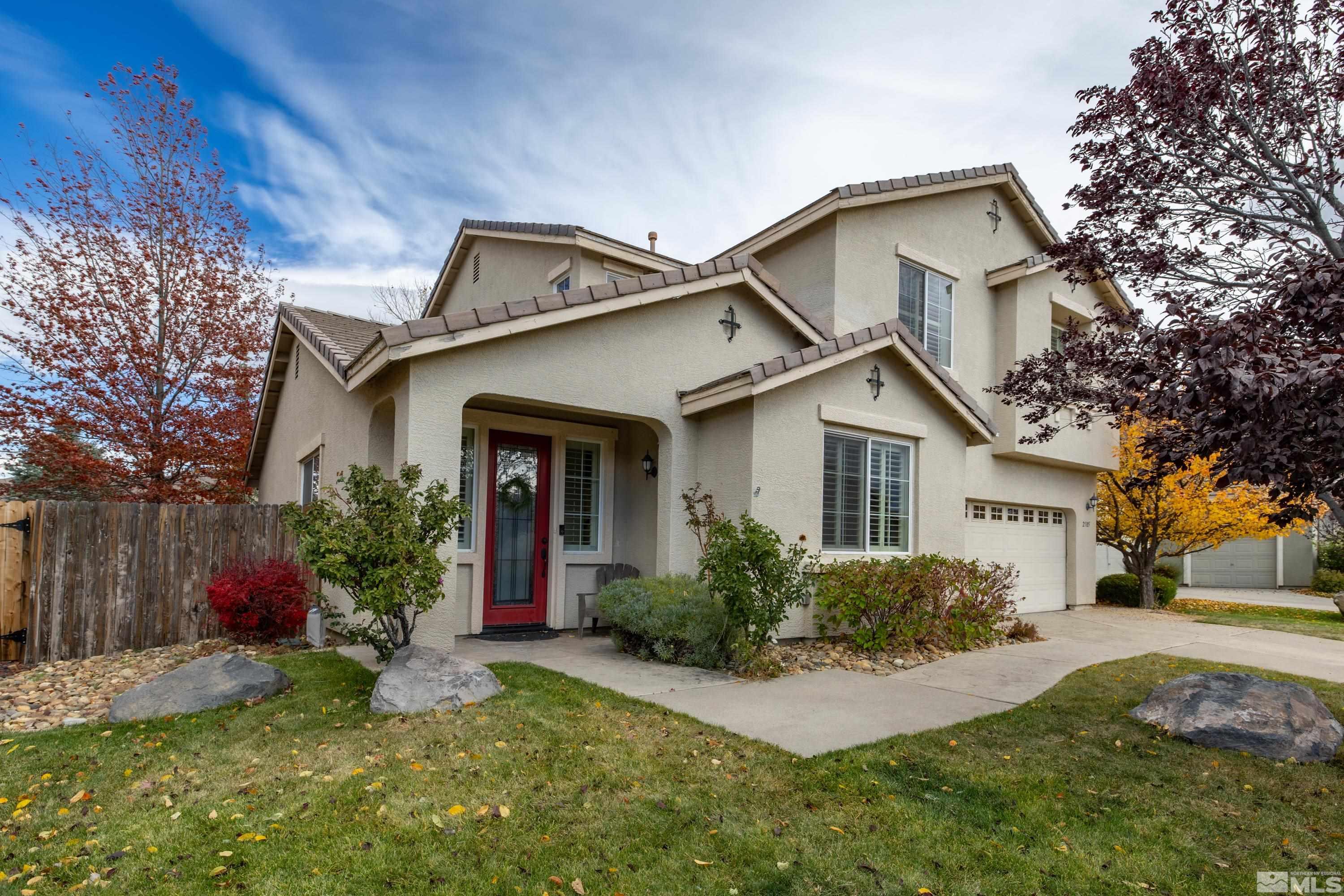 2585 Baton Drive Reno, NV 89521 - Photo 1 of 28 a front view of a house with a yard and trees