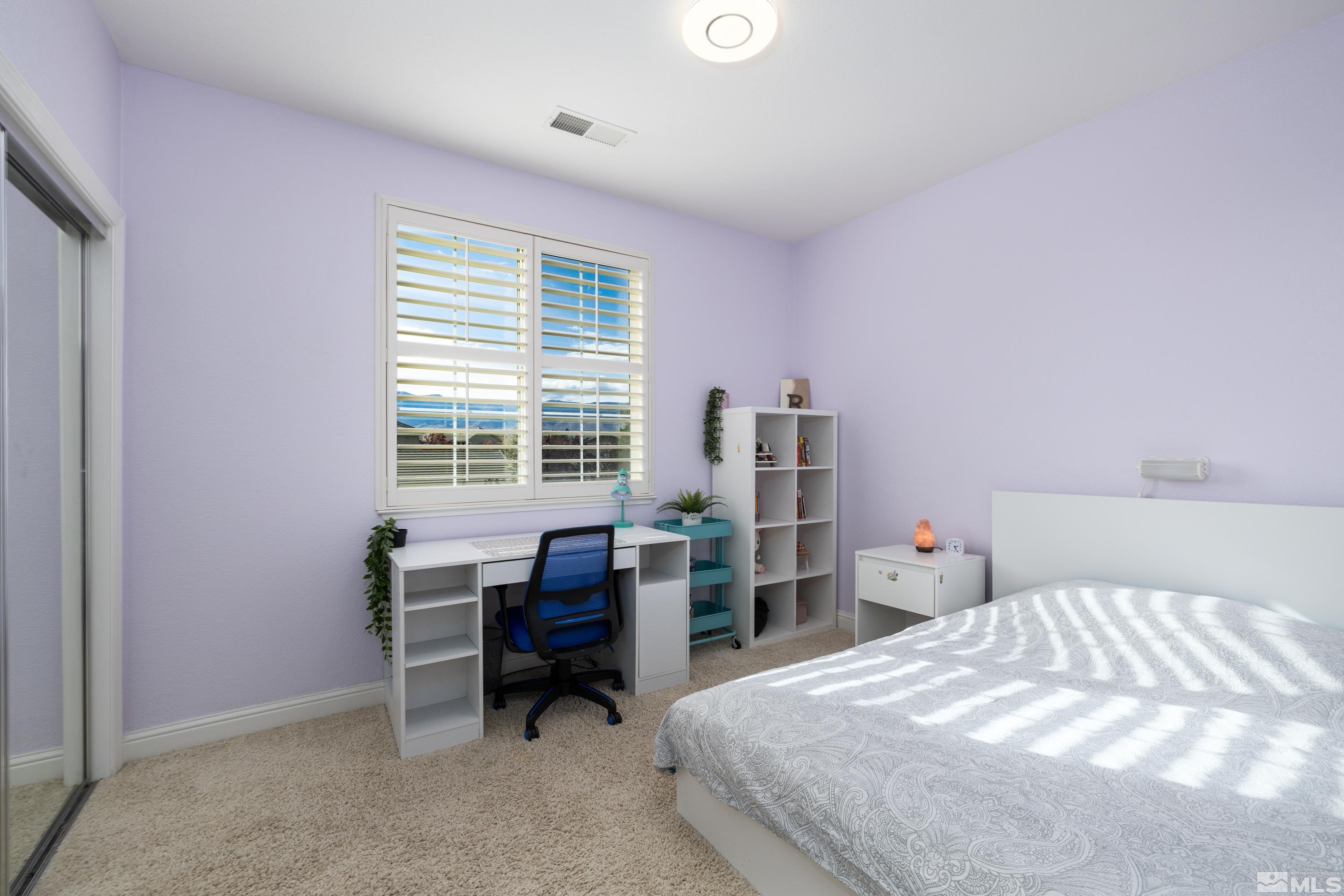 2585 Baton Drive Reno, NV 89521 - Photo 13 of 28 a bedroom with a bed and a desk in it