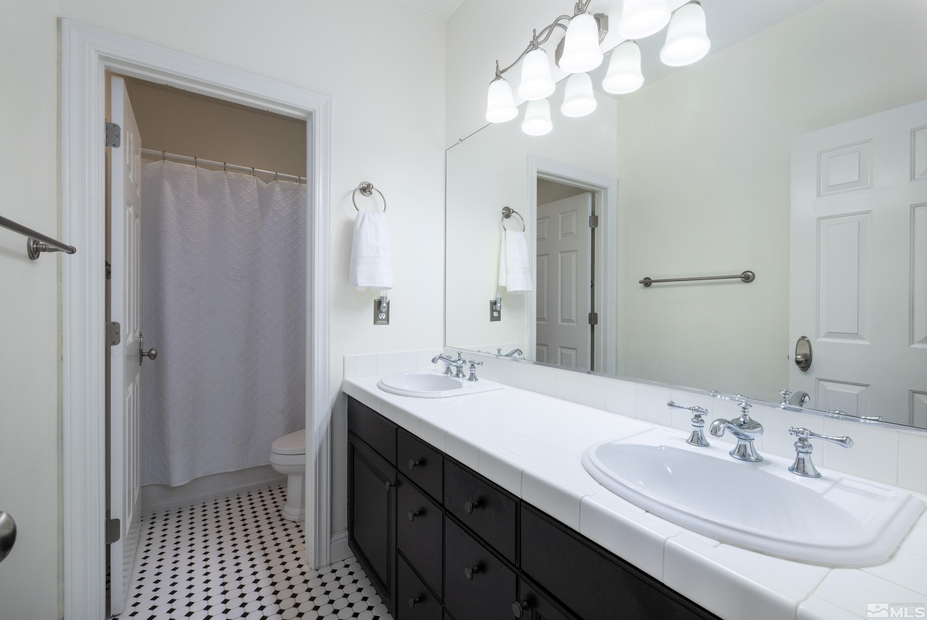 2585 Baton Drive Reno, NV 89521 - Photo 14 of 28 a bathroom with a sink a double vanity and a mirror