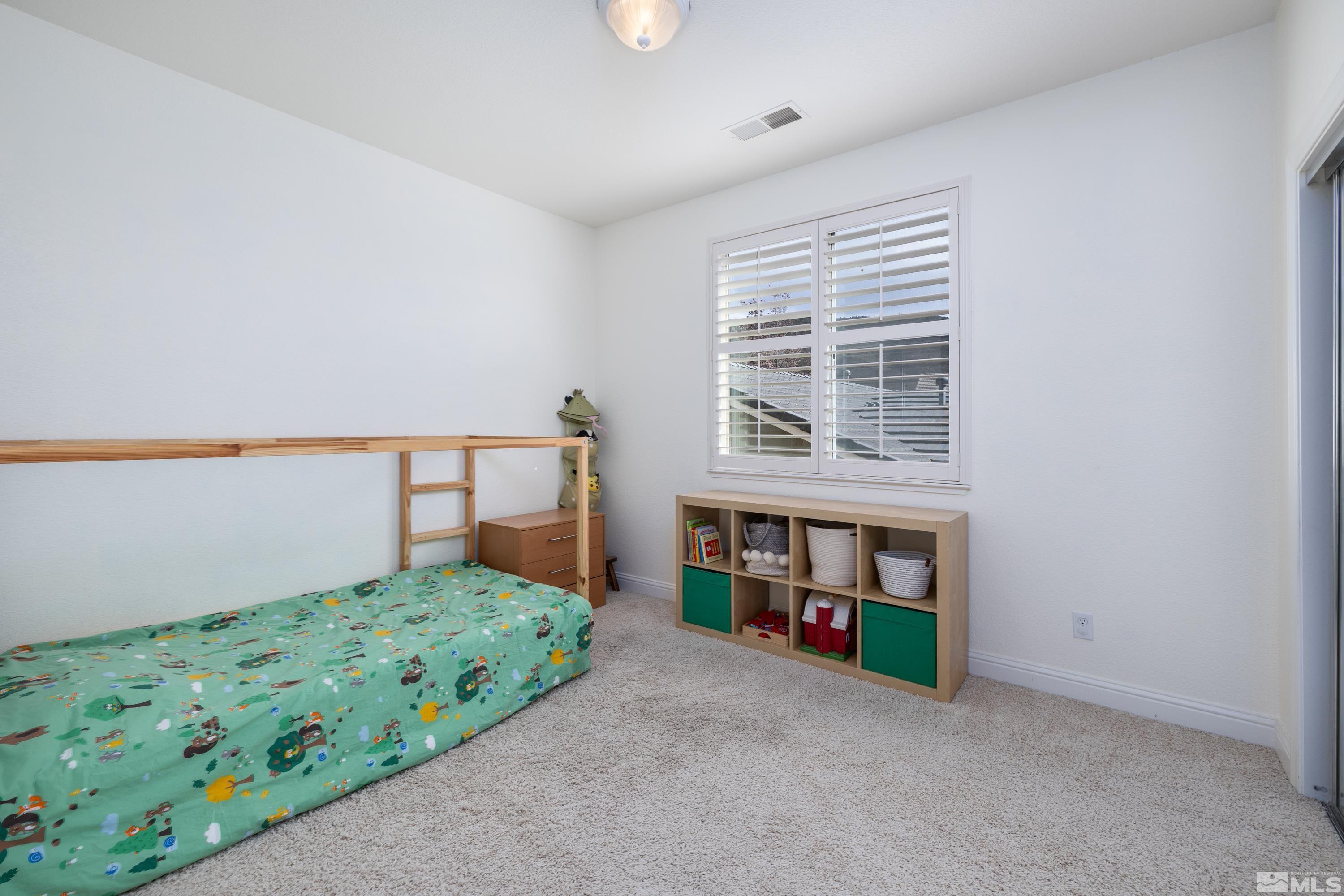 2585 Baton Drive Reno, NV 89521 - Photo 15 of 28 a living room with a bed furniture and a window