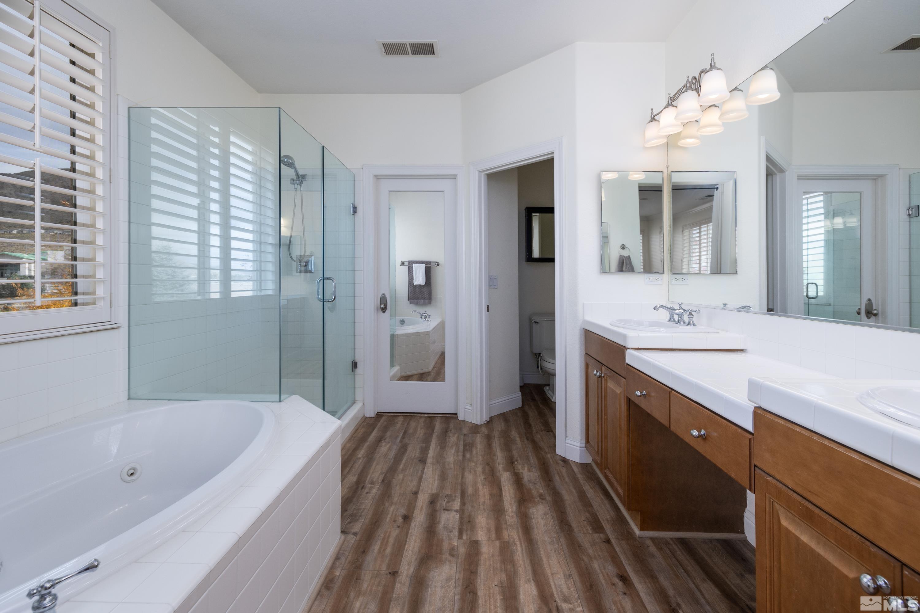 2585 Baton Drive Reno, NV 89521 - Photo 19 of 28 a spacious bathroom with a tub sink shower and mirror