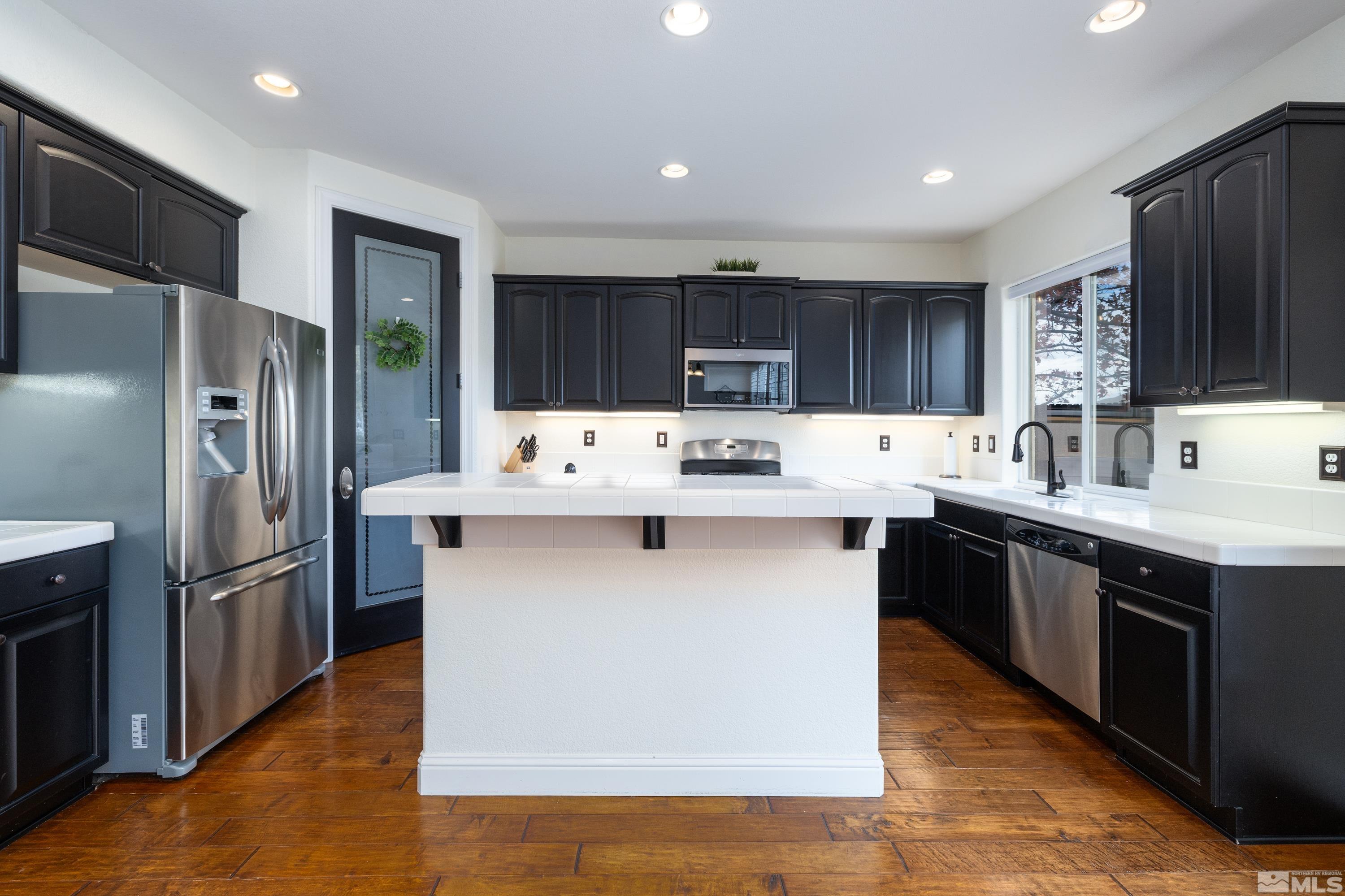 2585 Baton Drive Reno, NV 89521 - Photo 6 of 28 a kitchen with stainless steel appliances a refrigerator sink and cabinets