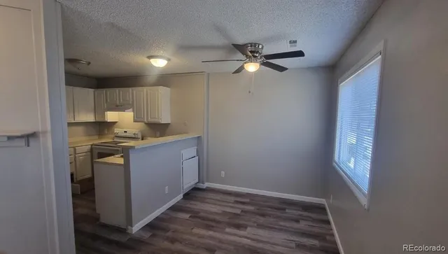 a kitchen with a refrigerator sink and cabinets