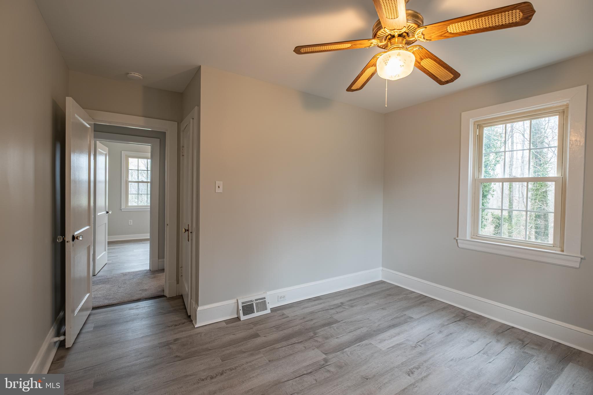 5680 Bryantown Road Bryantown, MD 20617 - Photo 12 of 33 wooden floor in an empty room with a window