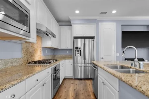 a kitchen with a sink cabinets and stainless steel appliances