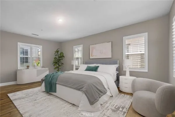 a bedroom with a bed and wooden floor