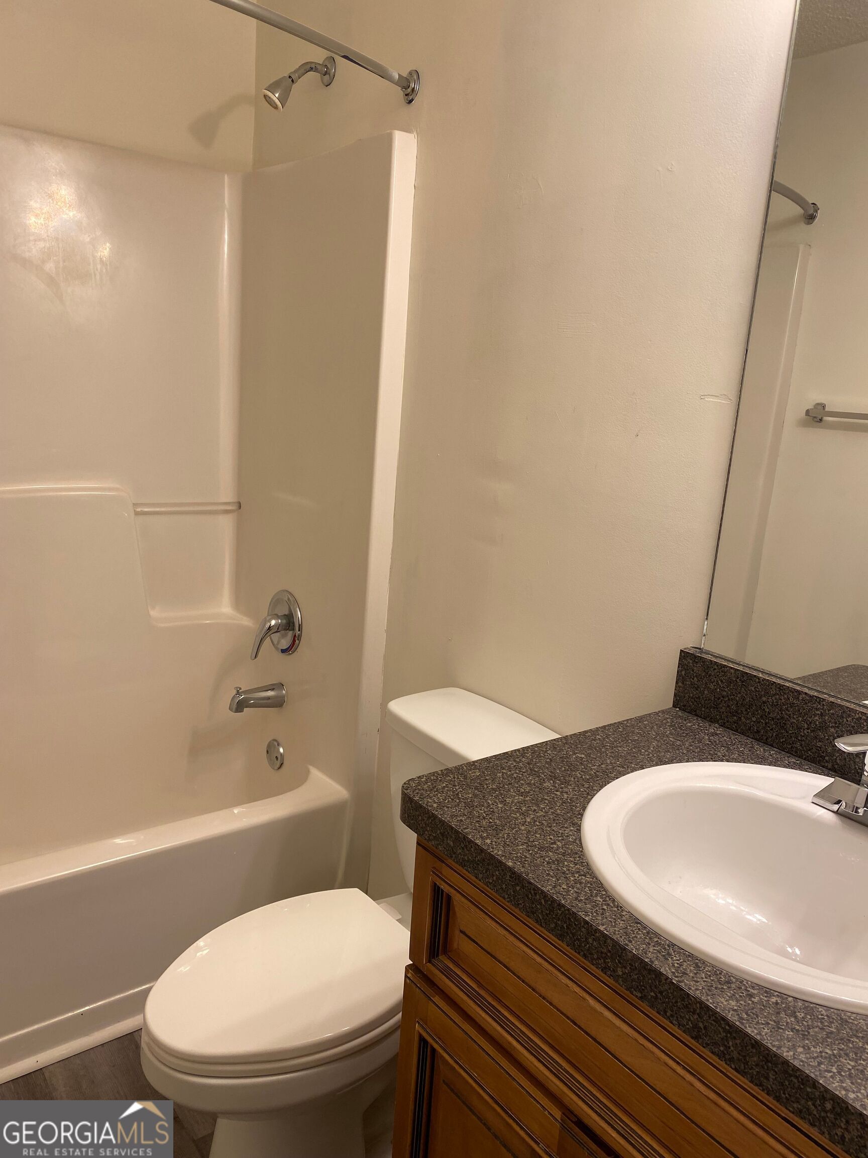 432 WI Parkway Dallas, GA 30132 - Photo 2 of 8 a bathroom with a granite countertop toilet sink and mirror