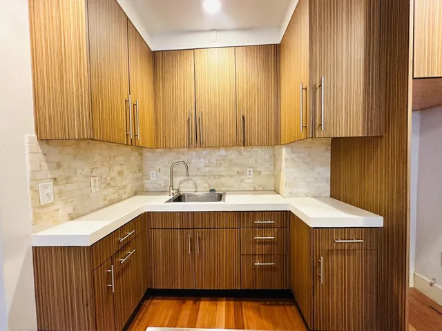 a kitchen with a sink cabinets and window