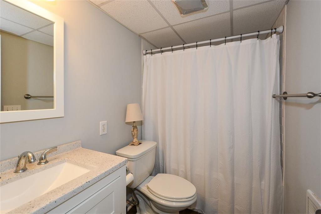 10 Arbor Hills Road South Talking Rock, GA 30175 - Photo 40 of 89 a bathroom with a sink a toilet a mirror and shower curtain