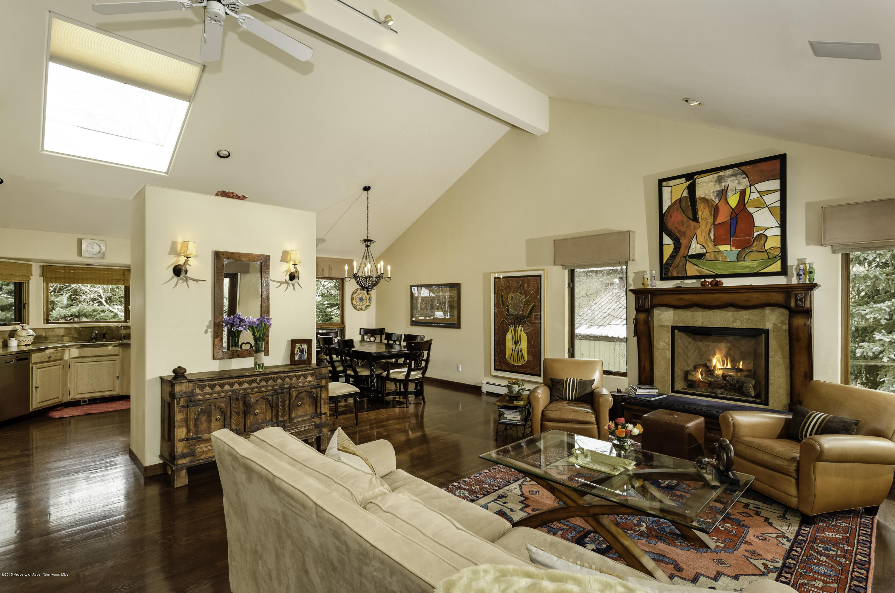 a living room with furniture large window and a fireplace