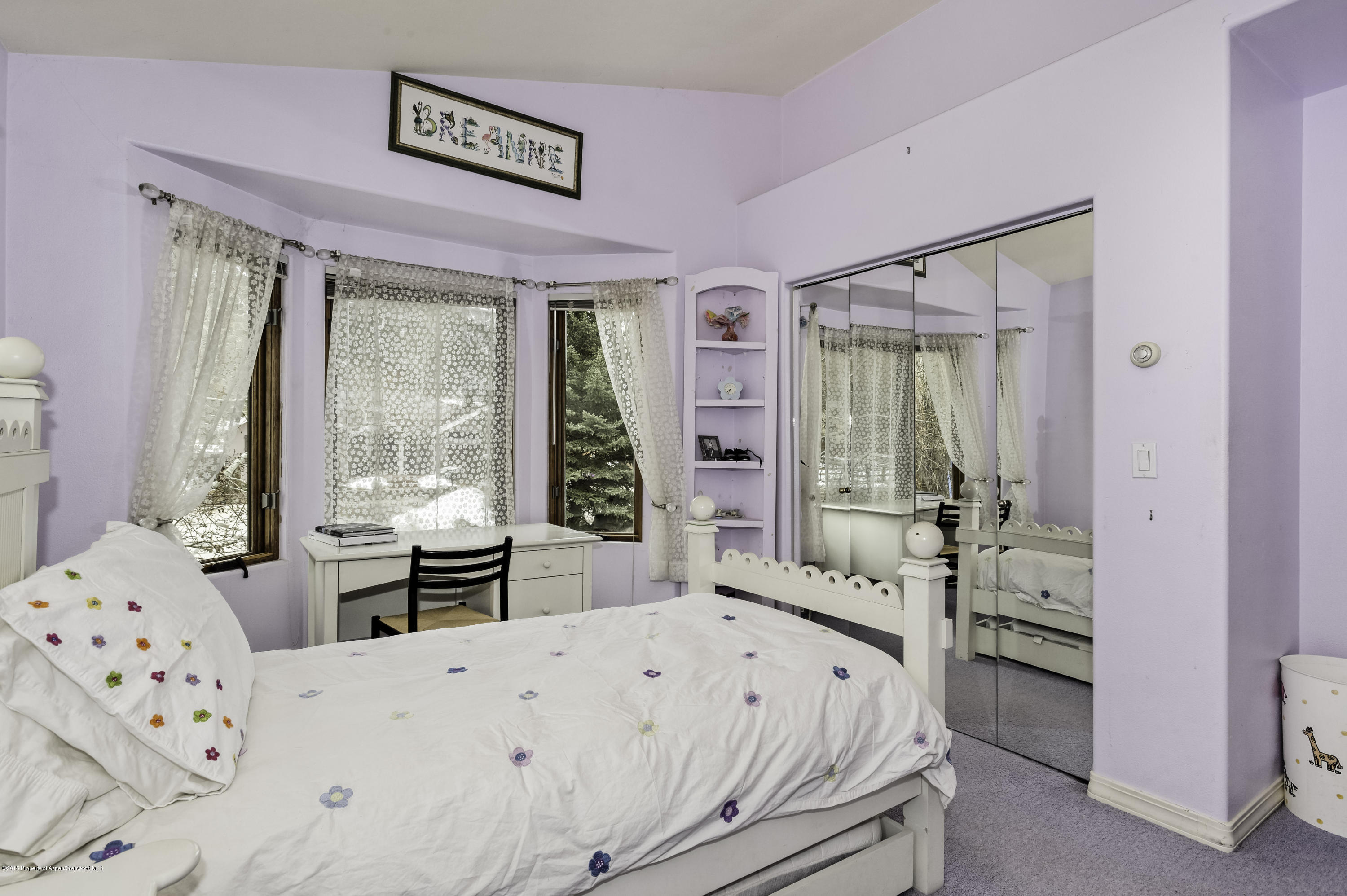 808 Kestrel Court Basalt, CO 81621 - Photo 14 of 22 a bedroom with a bed next to a large window with the outer view