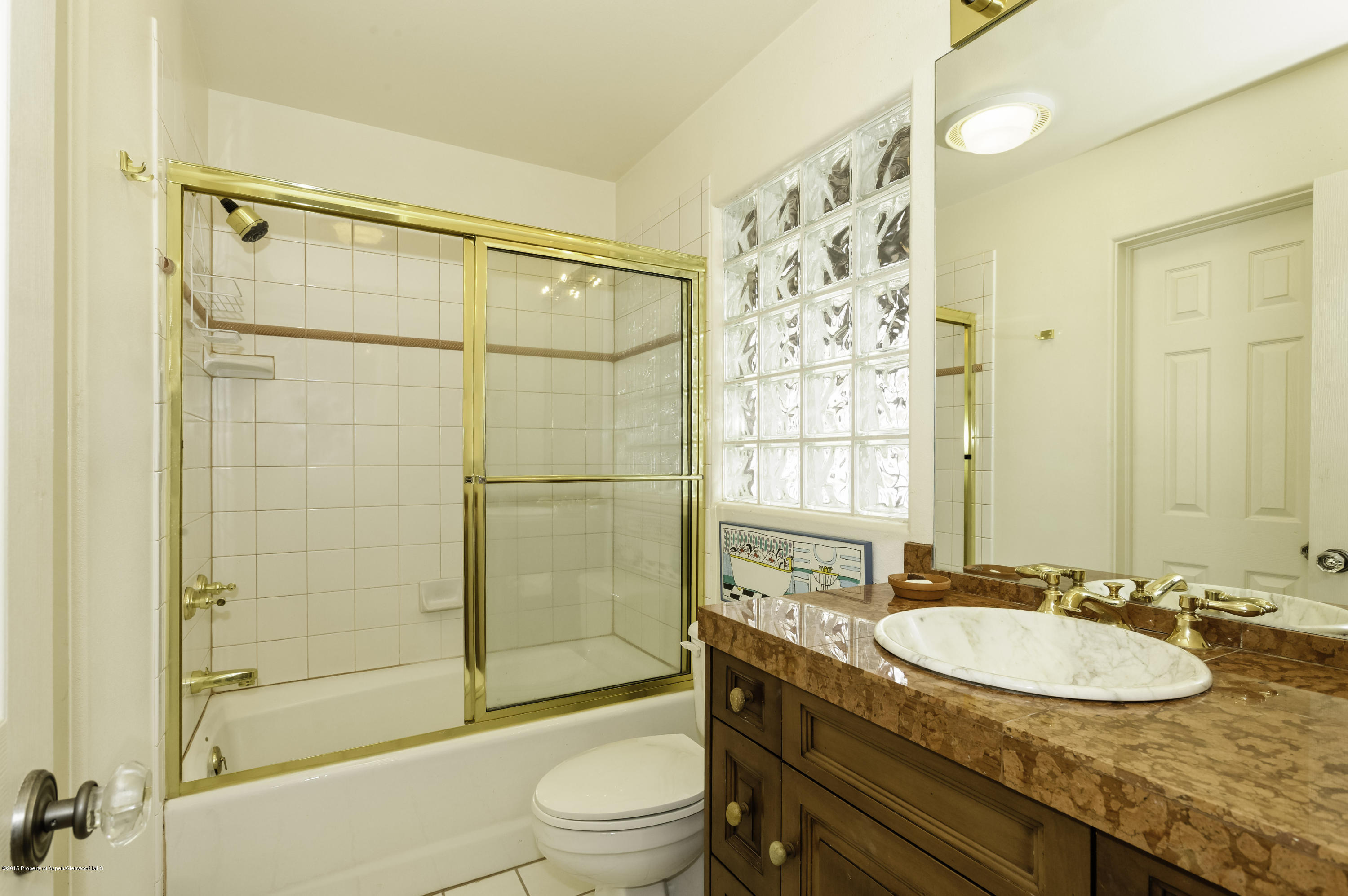 808 Kestrel Court Basalt, CO 81621 - Photo 19 of 22 a bathroom with a granite countertop sink toilet and shower