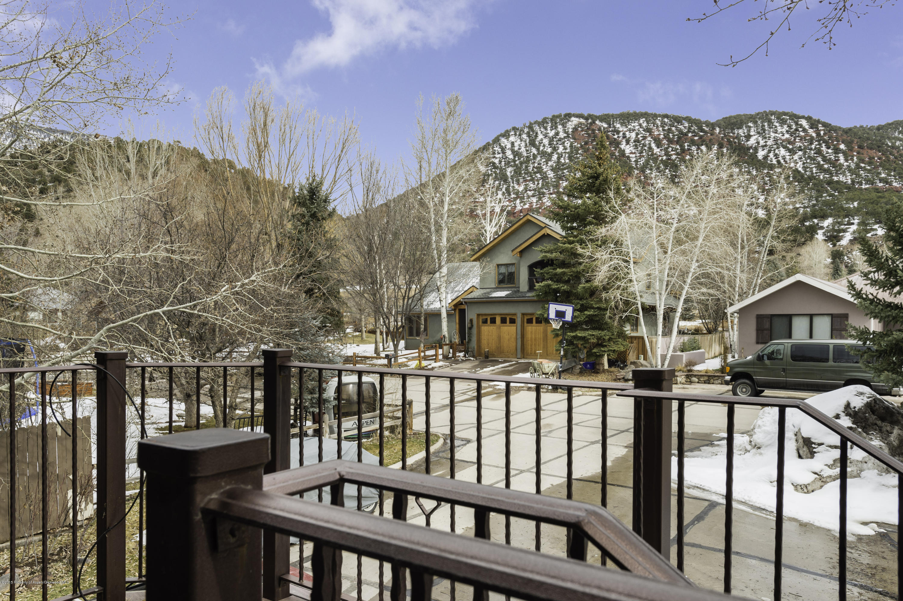 808 Kestrel Court Basalt, CO 81621 - Photo 22 of 22 a view of a brick house with large trees next to a yard