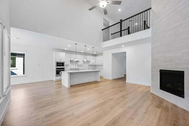 a view of kitchen with wooden floor and electronic appliances