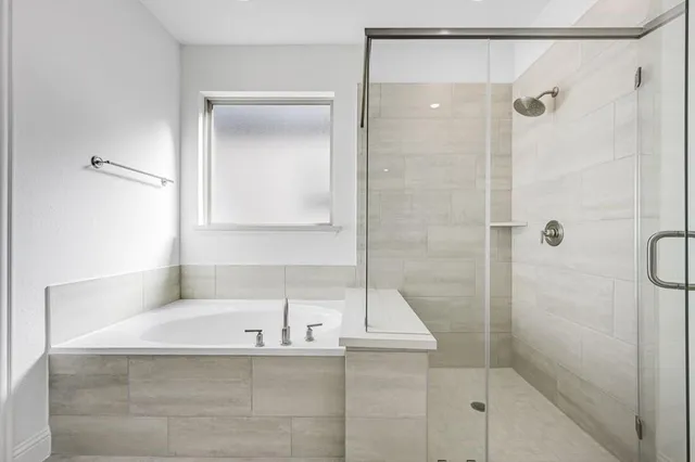 a bathroom with a bathtub and a shower