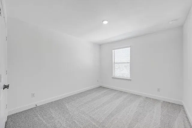 an empty room with a empty space and a window