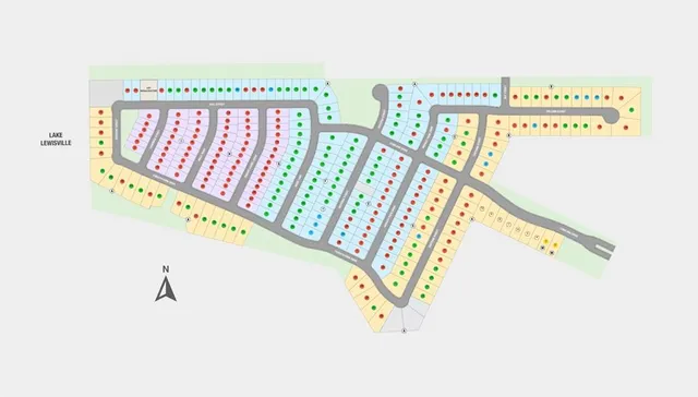 an aerial view of a residential building ocean and trees in the background