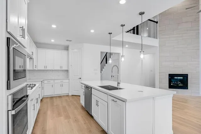 a kitchen with a sink stove and refrigerator