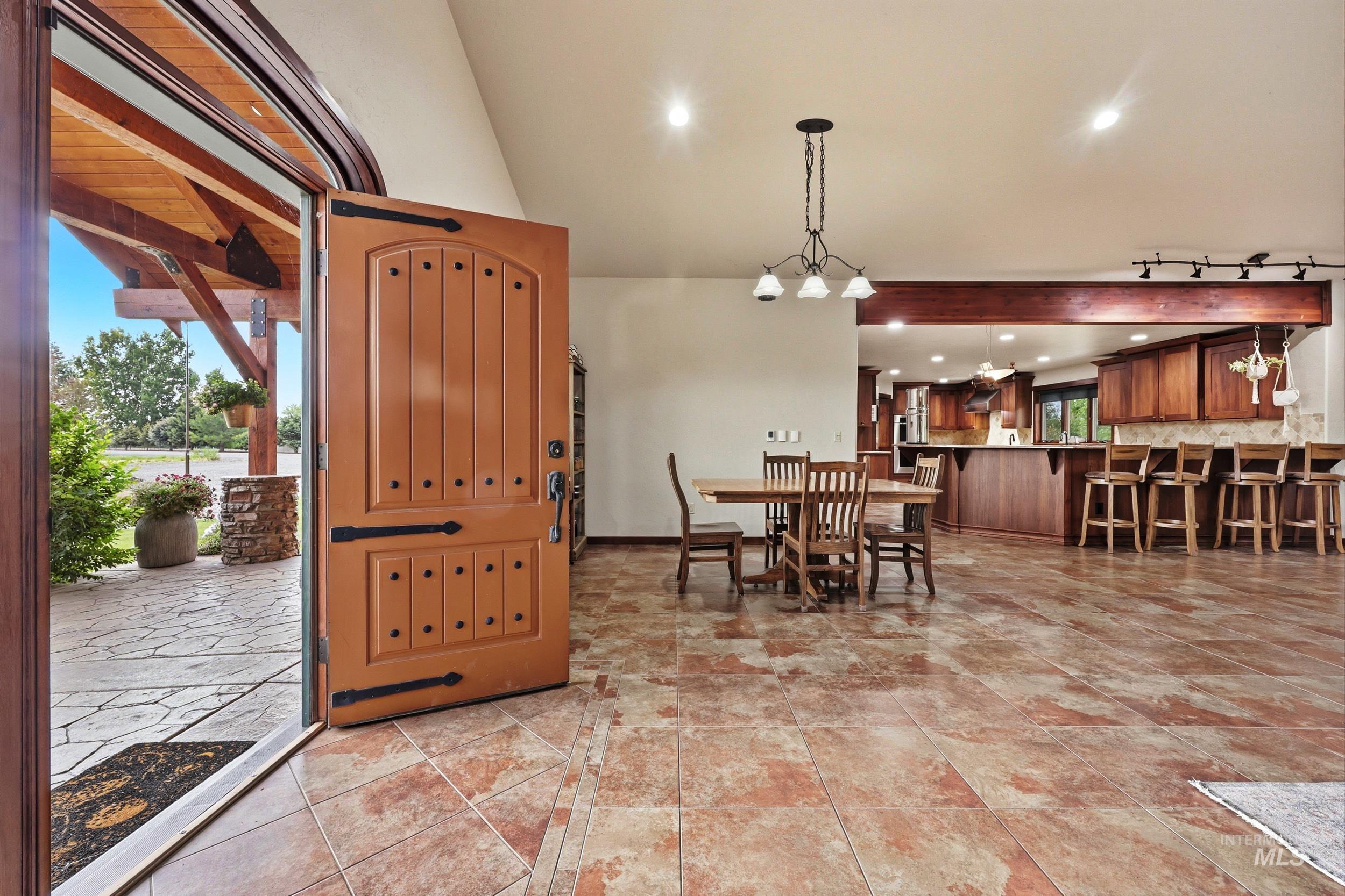 339 Airport Road Weiser, ID 83672 - Photo 6 of 49 Entryway featuring a solid wood front door with decorative iron hardware, opening to a tiled floor