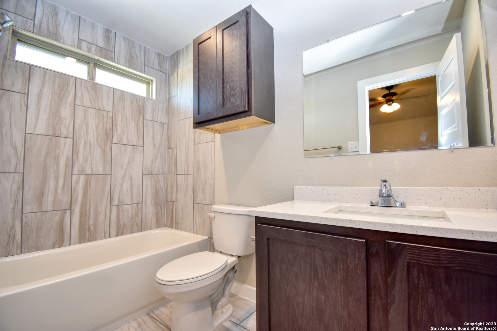 8318 Via Verona, Unit 103 San Antonio, TX 78227 - Photo 8 of 18 a bathroom with a sink a toilet and bathtub