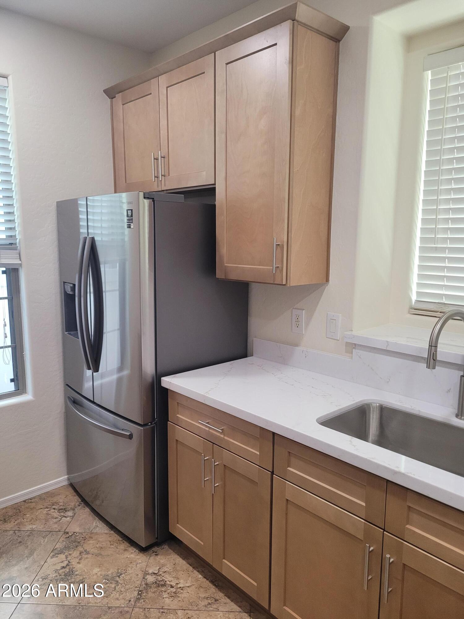 1453 South Sinova Avenue Gilbert, AZ 85296 - Photo 12 of 46 a kitchen with stainless steel appliances granite countertop a refrigerator sink and cabinets