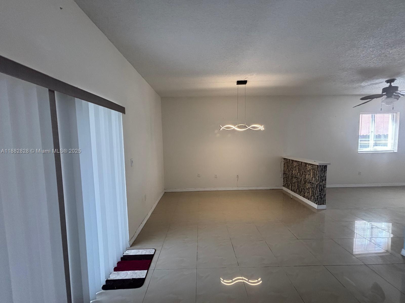 1133 Southeast 13th Terrace Homestead, FL 33035 - Photo 8 of 14 a view of an empty room with a window
