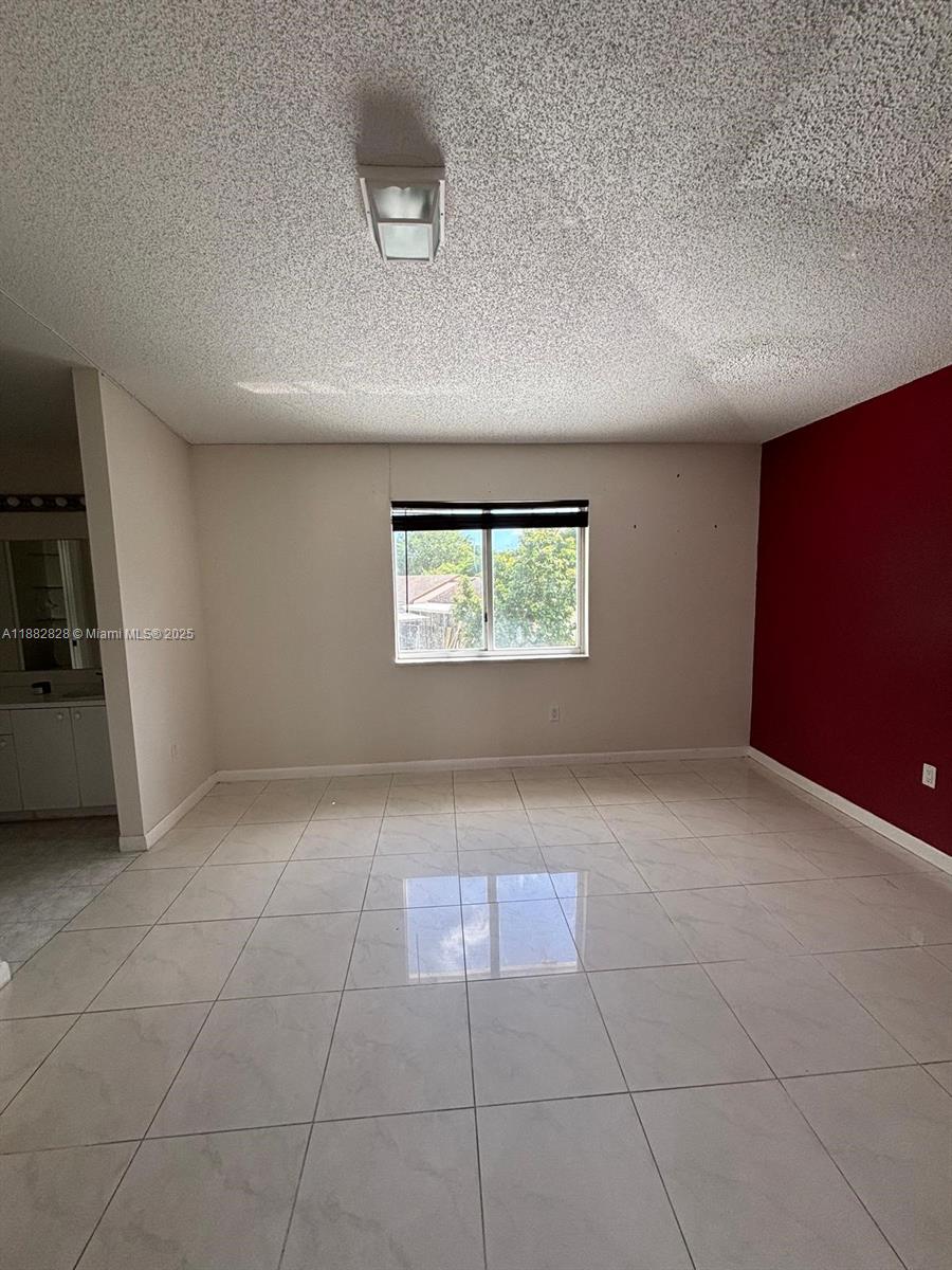 1133 Southeast 13th Terrace Homestead, FL 33035 - Photo 9 of 14 a view of an empty room with a window