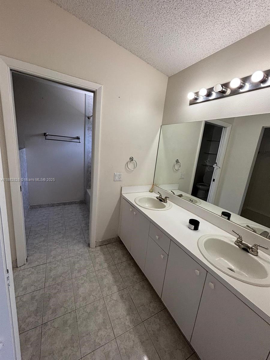 1133 Southeast 13th Terrace Homestead, FL 33035 - Photo 10 of 14 a bathroom with a double vanity sink and a mirror