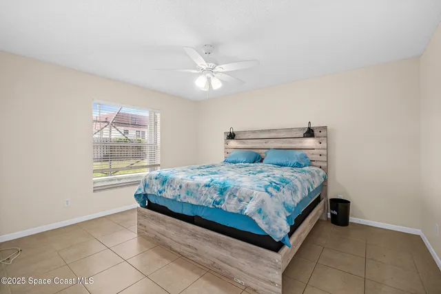 a bedroom with a bed and ceiling fan