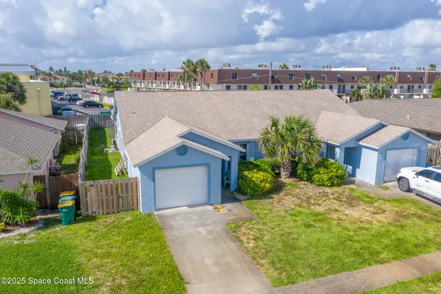 a view of a house with a garden and pathway