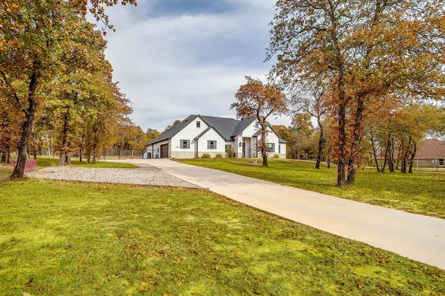 a view of swimming pool with large trees and a big yard