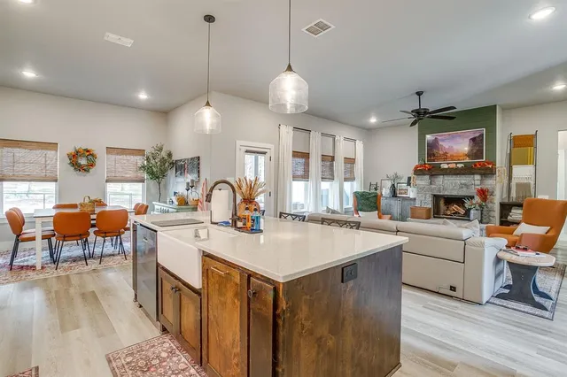 a large kitchen with sink and refrigerator