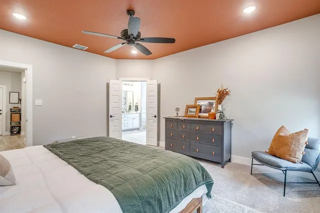 a bedroom with a bed and a chandelier