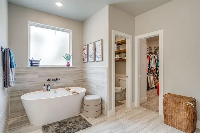 a white bath tub sitting next to a white sink