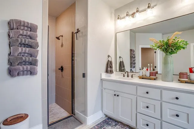 a bathroom with a double vanity sink and mirror