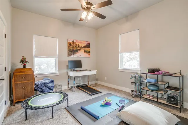 a living room with furniture a rug and a window