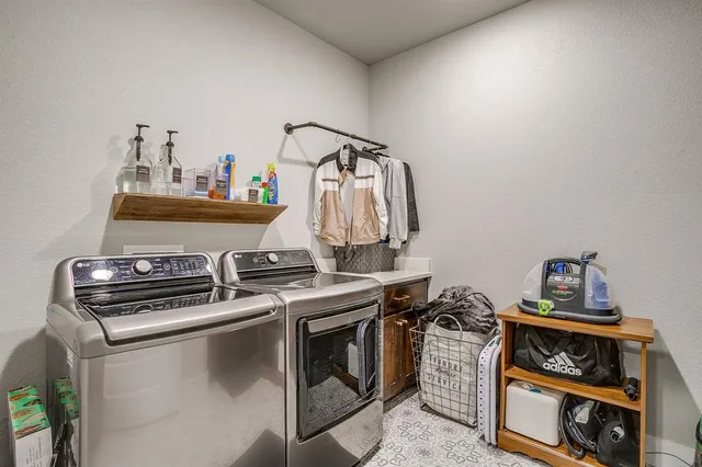 a utility room with dryer washer and sink