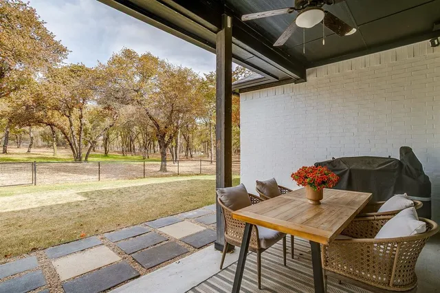 a view of a patio with table and chairs and couches with wooden floor