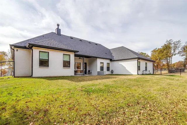 a house that has a big yard with large trees