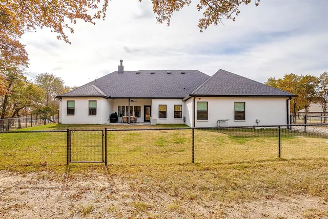 a view of a house with pool and a yard