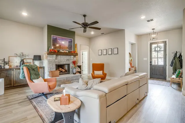 a living room with fireplace furniture and a flat screen tv