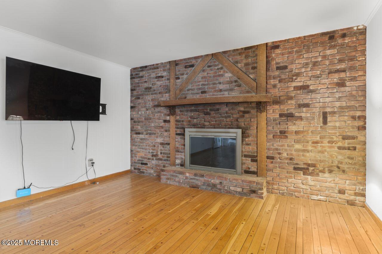 600 Driscol Drive Brick, NJ 08724 - Photo 13 of 35 a view of empty room with wooden floor and fireplace